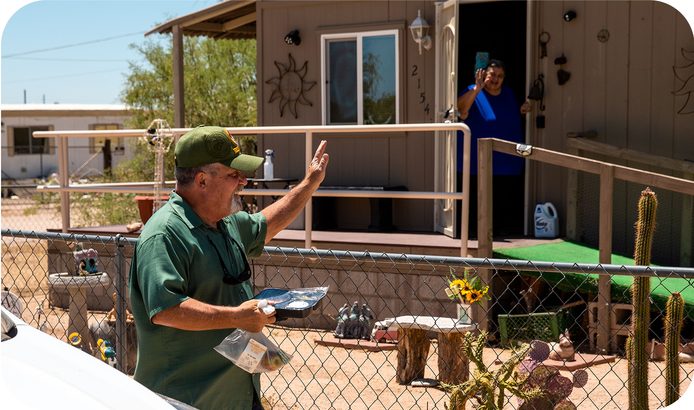 A man delivery meals to an elderly retirement community