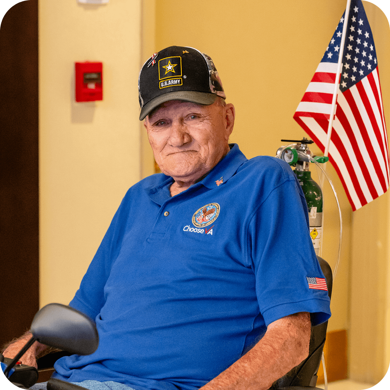 A senior man in an electric scooter chair standing in front of the USA flag